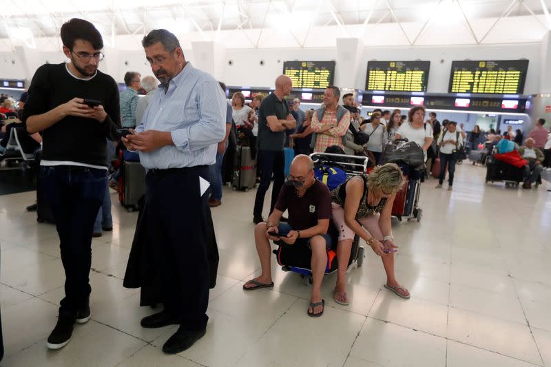 Stranded passengers wait at Las Palmas Airport in Gran Canaria, as a sandstorm locally known as "calima" closed air traffic in the Canary Islands