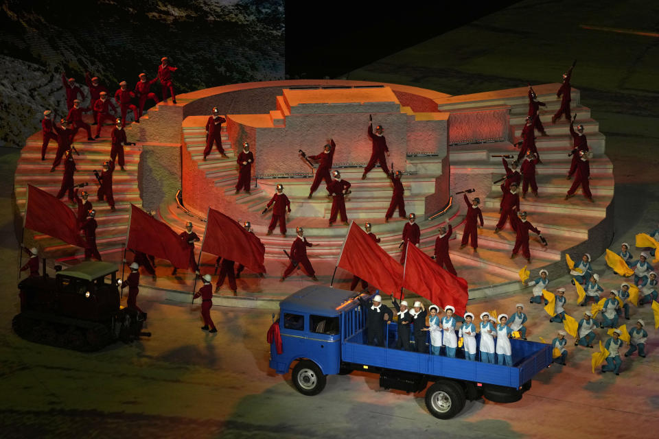 Performers take part in a gala show ahead of the 100th anniversary of the founding of the Chinese Communist Party in Beijing on Monday, June 28, 2021. A spectacular outdoor gala attended by Chinese President Xi Jinping in Beijing on Monday night relived what is known as the Long March of the 1930s, featured men singing with giant wrenches and women with bushels of wheat, and had special forces climbing a mountain and medical workers battling COVID-19 in protective gear. (AP Photo/Ng Han Guan)