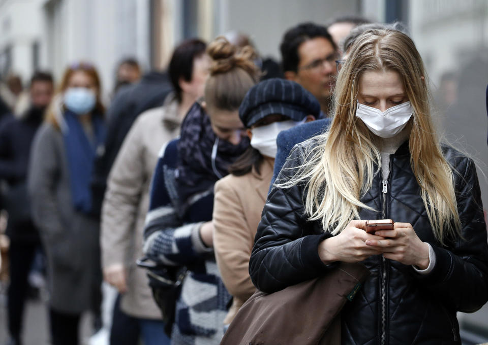 People in line wearing masks