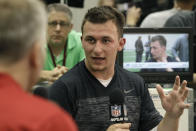 Texas A&M quarterback Johnny Manziel talks to members of the media during pro day for NFL football representatives in College Station, Texas, Thursday, March 27, 2014. (AP Photo/Patric Schneider)