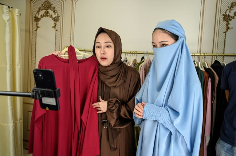 Chinese students at an e-commerce school rehearse selling hijabs and abayas into a smartphone (Jade GAO)