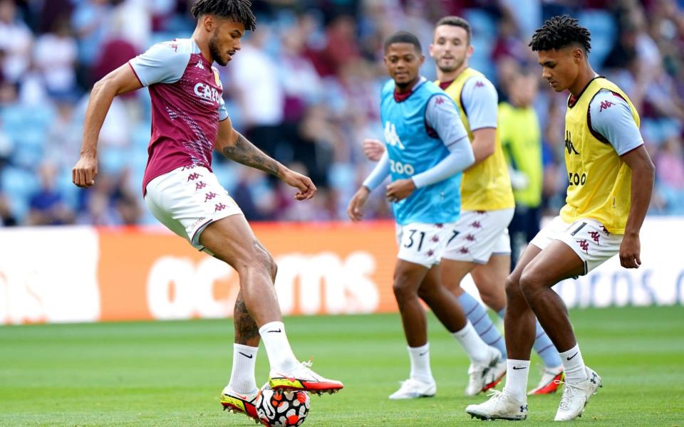 Aston Villa's Tyrone Mings (left) warms up on the pitch ahead of the Premier League match at Villa Park. - Tim Goode/PA Wire