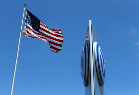 FILE PHOTO: A U.S. flag flutters in the wind above a Volkswagen automobile dealership in Carlsbad, California, U.S. May 2, 2016. REUTERS/Mike Blake/File Photo