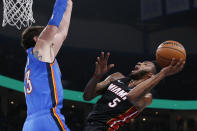 Miami Heat forward Derrick Jones Jr. (5) shoots as Oklahoma City Thunder forward Mike Muscala defends during the first half of an NBA basketball game Friday, Jan. 17, 2020, in Oklahoma City. (AP Photo/Sue Ogrocki)