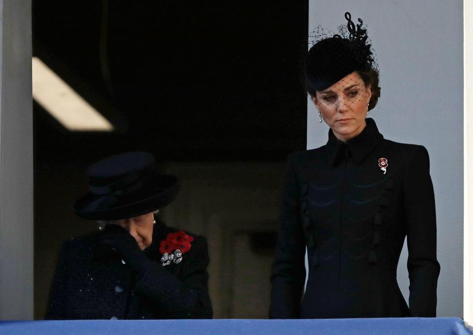 Queen Elizabeth II wipes her eye as she stands with Duchess Kate to watch the Remembrance Sunday ceremony at The Cenotaph in London on Nov. 10, 2019.