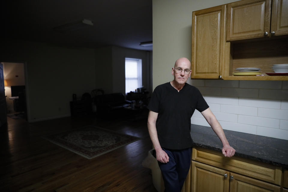 Joseph, 56, who lives with mood disorders, stands in his apartment alone as he speaks about the stresses of social distancing following a medication delivery from Dr. Jeanie Tse, chief medical officer at the Institute for Community Living, on her rounds treating patients, Wednesday, May 6, 2020, in the Brooklyn borough of New York. (AP Photo/John Minchillo)