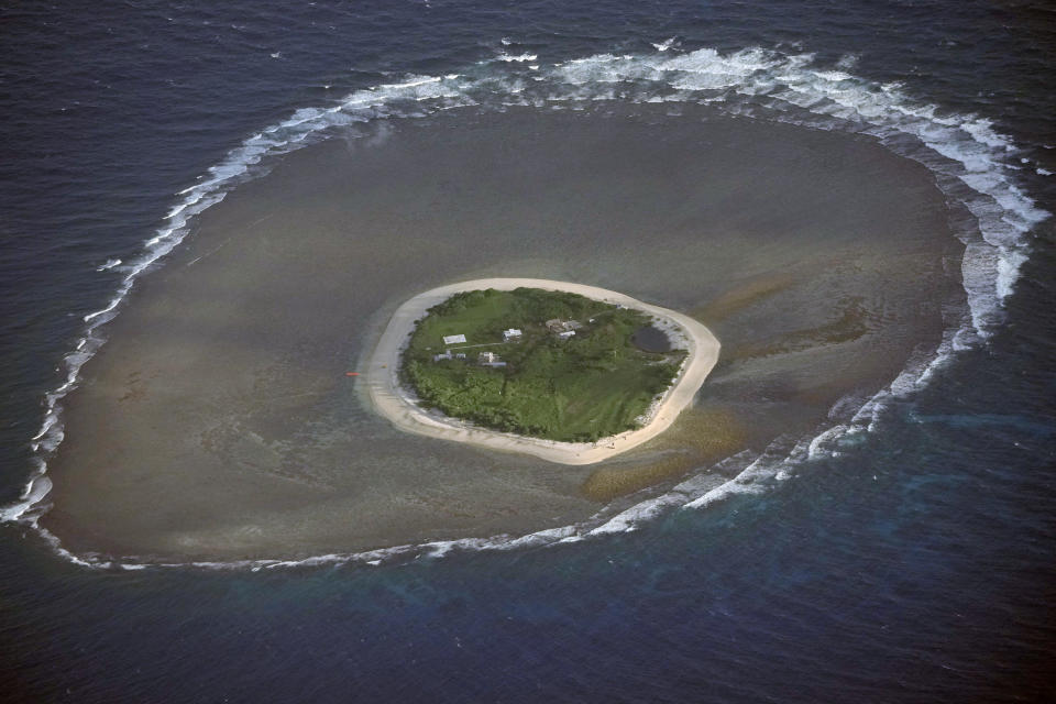 Waves surround the Philippine-occupied Nanshan Island, locally known as Lawak Island, on Friday, Dec. 1, 2023 at the disputed South China Sea. The Philippine coast guard inaugurated a new monitoring base Friday on Thitu island occupied by Filipino forces in the disputed South China Sea as Manila ramps up efforts to counter China's increasingly aggressive actions in the strategic waterway. (AP Photo/Aaron Favila)