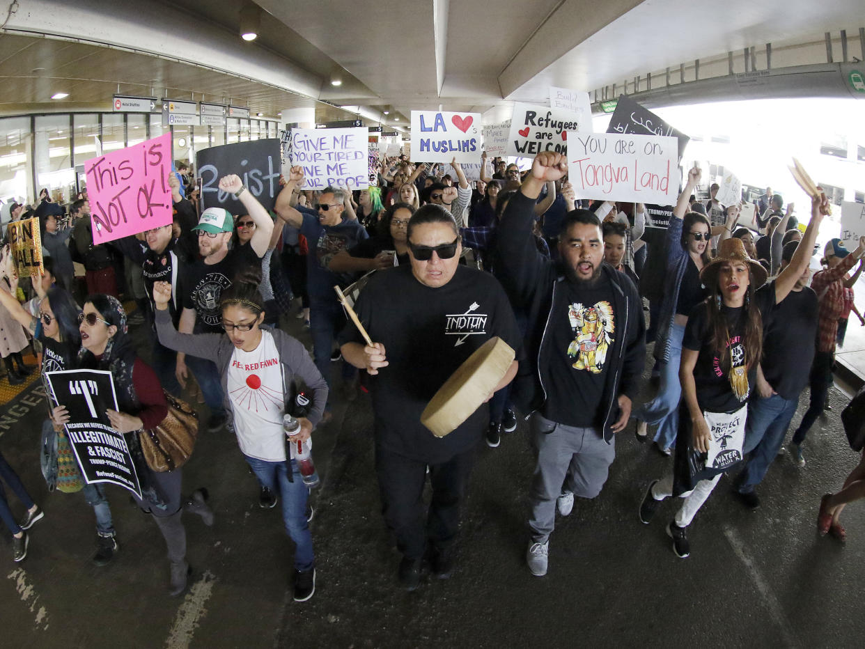 Demonstrators march on the lower roadway as protests against President Donald Trump's executive order banning travel to the U.S: AP