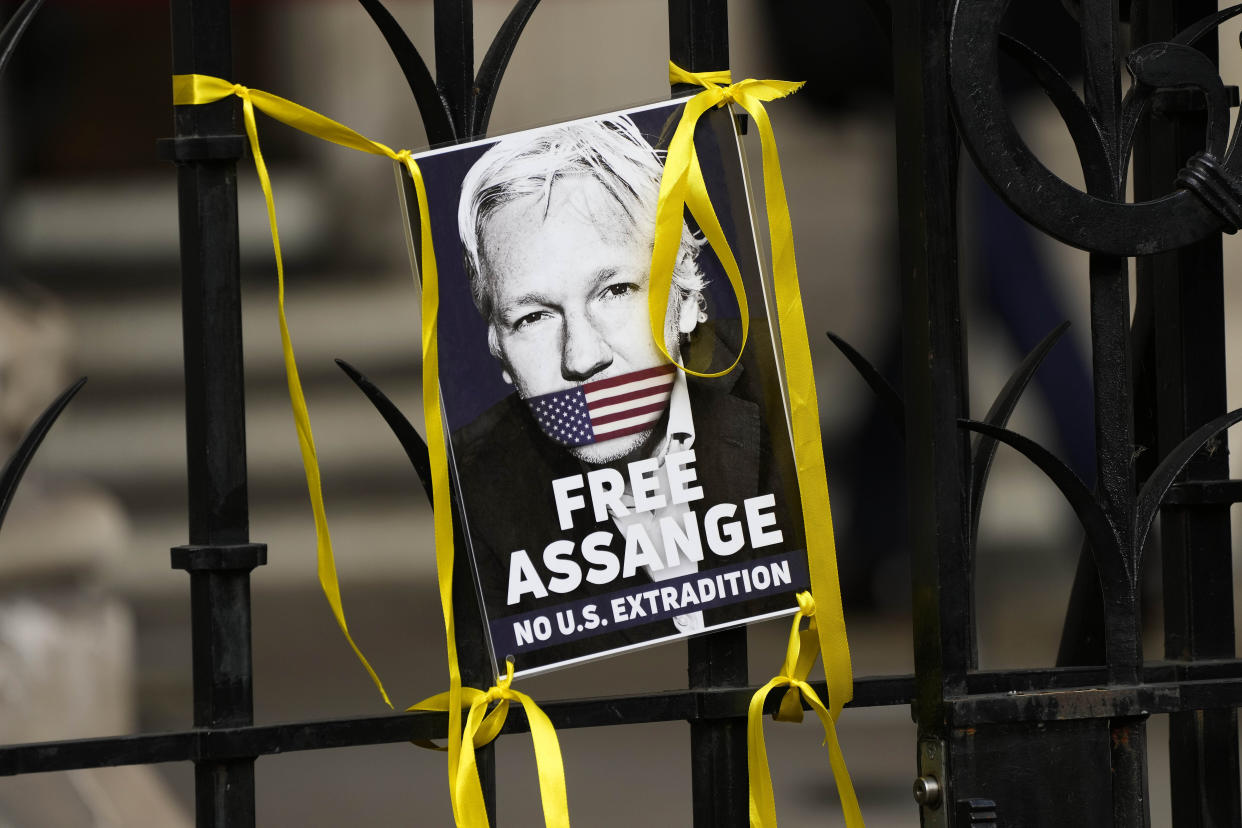 A poster of Julian Assange is fixed at the entrance gate outside the High Court in London, Wednesday, Oct. 27, 2021. (Frank Augstein/AP)