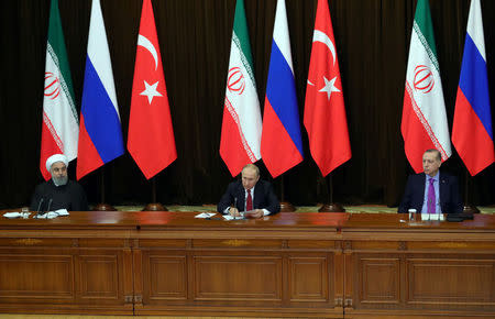 Iran's President Hassan Rouhani together with his counterparts, Russia's Vladimir Putin and Turkey's Tayyip Erdogan, attend a joint news conference following their meeting in Sochi, Russia November 22, 2017. Sputnik/Mikhail Klimentyev/Kremlin via REUTERS ATTENTION EDITORS - THIS IMAGE WAS PROVIDED BY A THIRD PARTY.