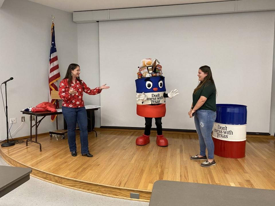 Flour Bluff High School senior Julia Gilliam, right, won a Texas Department of Transportation scholarship contest. From the left, Brandy Williams, account supervisor with GDC Marketing and Ideation, the firm that works with the department's anti-litter campaign, and the "Don't Mess with Texas" mascot visited Gilliam to surprise her with the award on May 18, 2022, at the school.