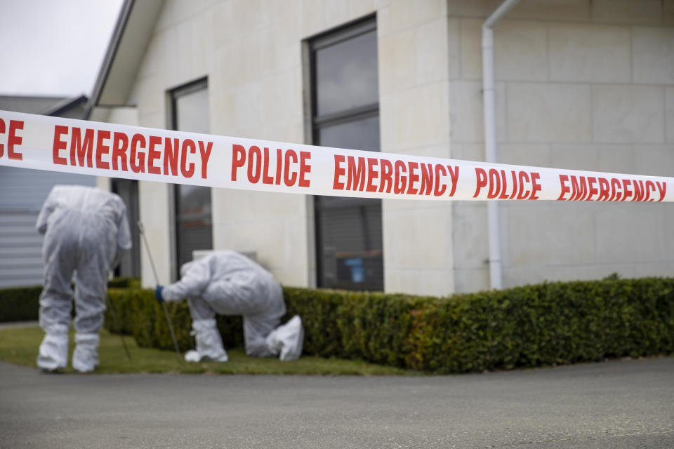 Police search a garden near a house where three children were found dead in the South Island town of Timaru, New Zealand, Friday, Sept. 17, 2021. Three young children who had just moved to New Zealand from South Africa have died in what police are investigating as homicide. (George Heard/New Zealand Herald via AP)