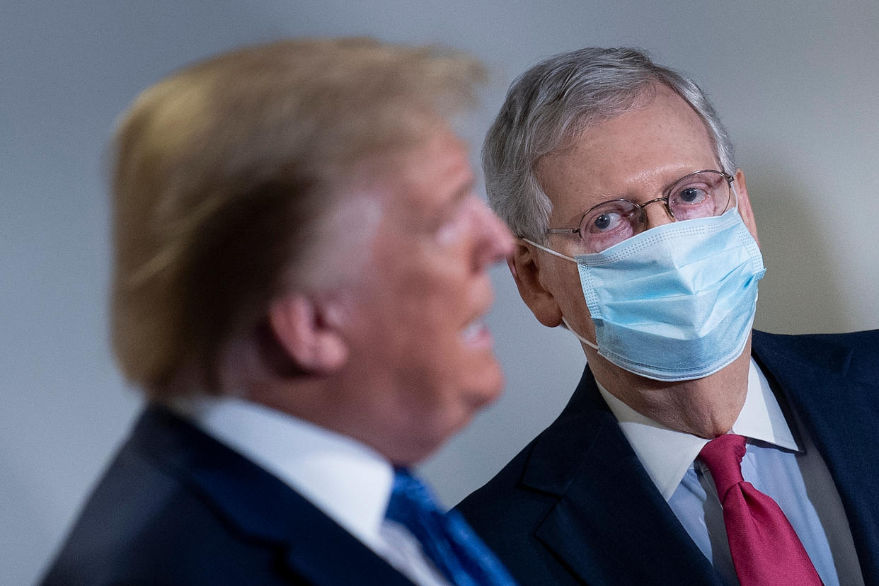 US Senate Majority Leader Mitch McConnell (L) listens to US President Donald Trump speak during a press conference following the Senate Republicans policy luncheon on Capitol Hill in Washington, DC, on May 19, 2020. (Photo by Brendan Smialowski / AFP) (Photo by BRENDAN SMIALOWSKI/AFP via Getty Images)