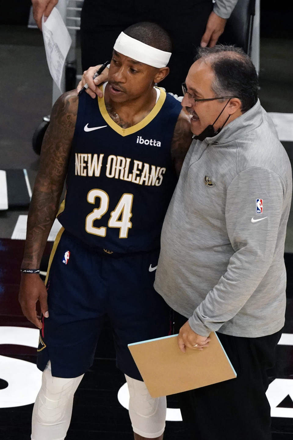 New Orleans Pelicans head coach Stan Van Gundy talks to guard Isaiah Thomas (24) in the second half of an NBA basketball game against the Atlanta Hawks Tuesday, April 6, 2021, in Atlanta. (AP Photo/John Bazemore)