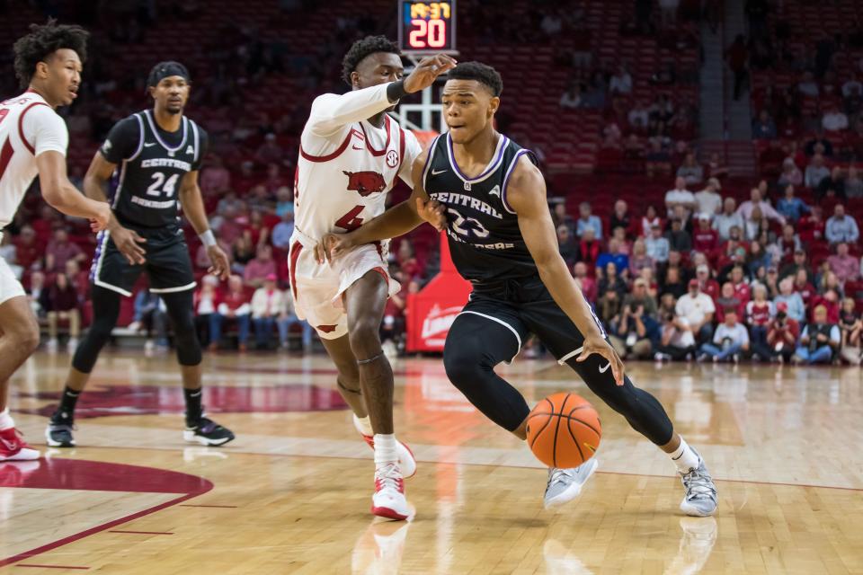 Dec 1, 2021; Fayetteville, Arkansas, USA; Central Arkansas Bears guard Camren Hunter (23) drives around Arkansas Razorbacks guard Davonte Davis (4) during the first half at Bud Walton Arena. Mandatory Credit: Brett Rojo-USA TODAY Sports