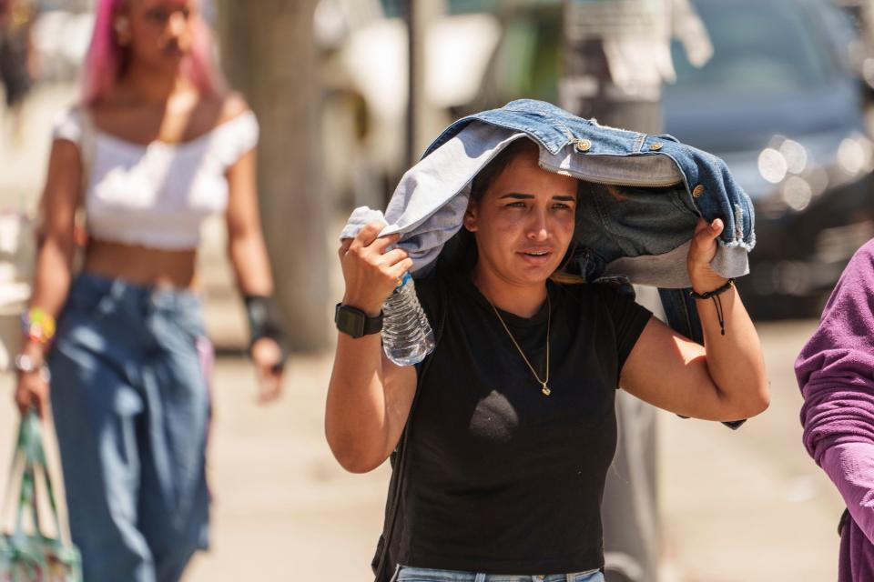 Sorelly Restrepo shields from the sunlight in the Little Tokyo district of Los Angeles on July 27, 2023.