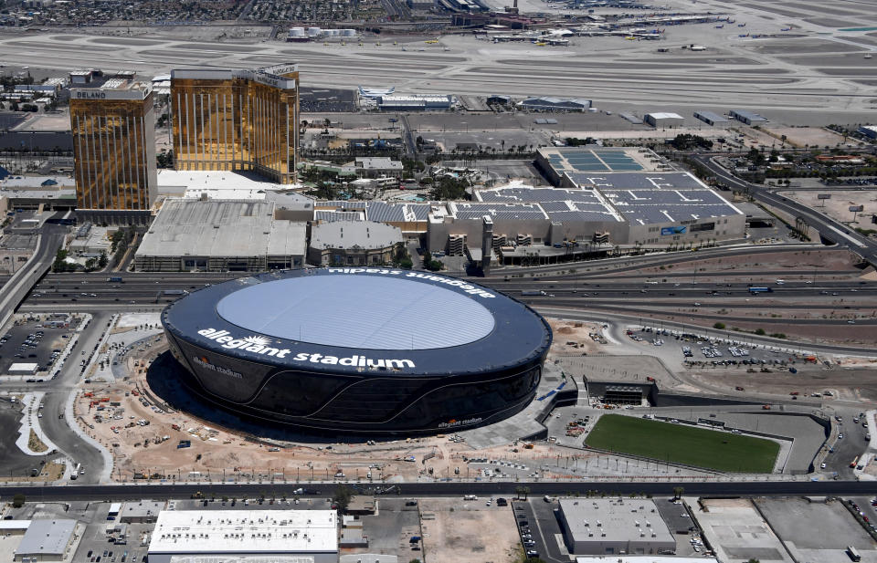 LAS VEGAS, NEVADA - MAY 21:  (L-R) An aerial view shows Delano Las Vegas at Mandalay Bay Resort and Casino and Mandalay Bay Resort and Casino on the Las Vegas Strip east of the construction continuing at Allegiant Stadium, the USD 2 billion, glass-domed home of the Las Vegas Raiders on May 21, 2020 in Las Vegas, Nevada. Natural grass turf now covers the large field tray that sits on rollers that will move the field in and out of the stadium. The Raiders are scheduled to play their first preseason game at the 65,000-seat facility on August 27 against the Arizona Cardinals.  (Photo by Ethan Miller/Getty Images)