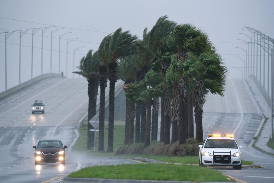 A public safety officer sits at the base of the Jacksonville side of the Beach Boulevard bridge as the winds and rain from Hurricane Dorian build in 2019. If sustained wind speeds reach 40 mph during the approaching Hurricane Ian, bridges will be blocked off.