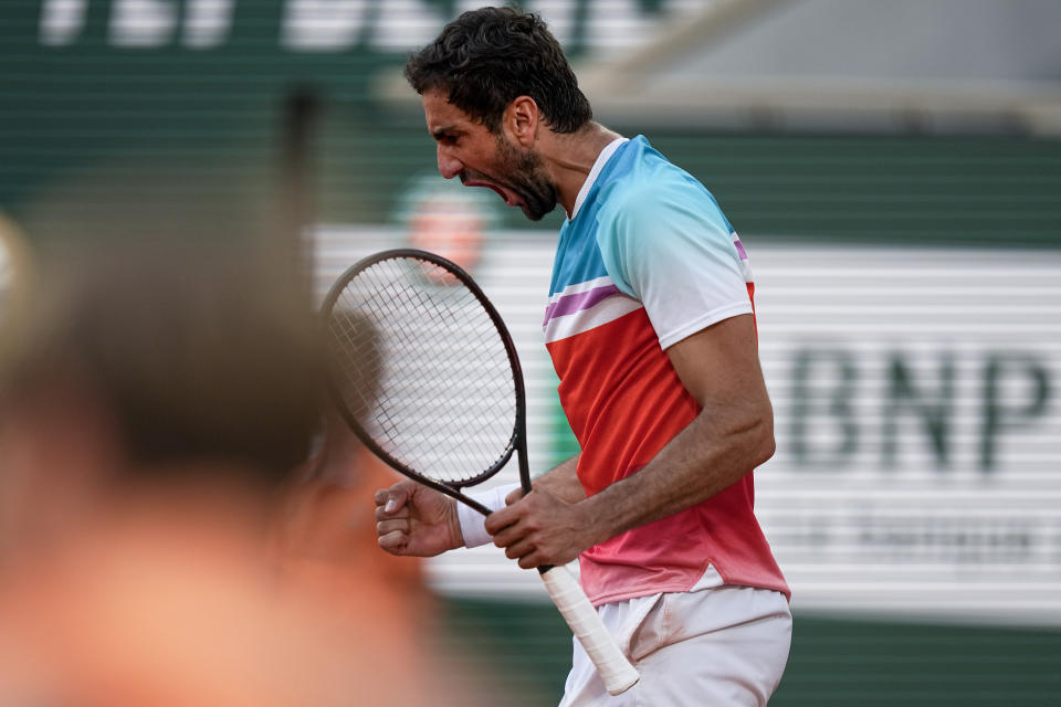 Croatia's Marin Cilic clenches his fist after scoring a point against Russia's Andrey Rublev during their quarterfinal match at the French Open tennis tournament in Roland Garros stadium in Paris, France, Wednesday, June 1, 2022. (AP Photo/Michel Euler)