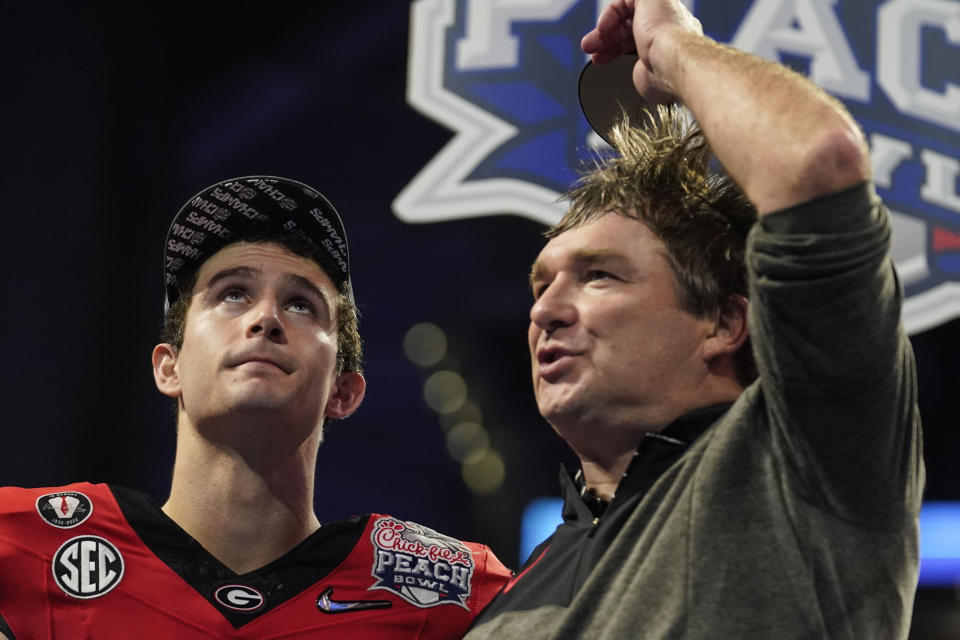 Georgia quarterback Stetson Bennett celebrates with Georgia head coach Kirby Smart after the Peach Bowl NCAA college football semifinal playoff game between Georgia and Ohio State, Sunday, Jan. 1, 2023, in Atlanta. Georgia won 42-41.(AP Photo/Brynn Anderson)