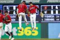 Cleveland Guardians shortstop Amed Rosario (1) and left fielder Steven Kwan celebrate an 8-4 win against the Detroit Tigers in a baseball game Wednesday, Aug. 17, 2022, in Cleveland. (AP Photo/Ron Schwane)