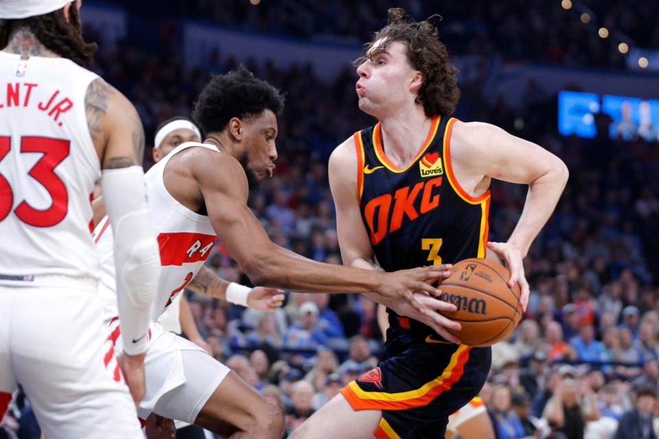 Oklahoma City Thunder guard Josh Giddey (3) tries to get past Toronto Raptors forward Thaddeus Young (21) during an NBA basketball game between the Oklahoma City Thunder and the Toronto Raptors at Paycom Center in Oklahoma City, Sunday, Feb. 4, 2024. Oklahoma City win 135-127 in double overtime.