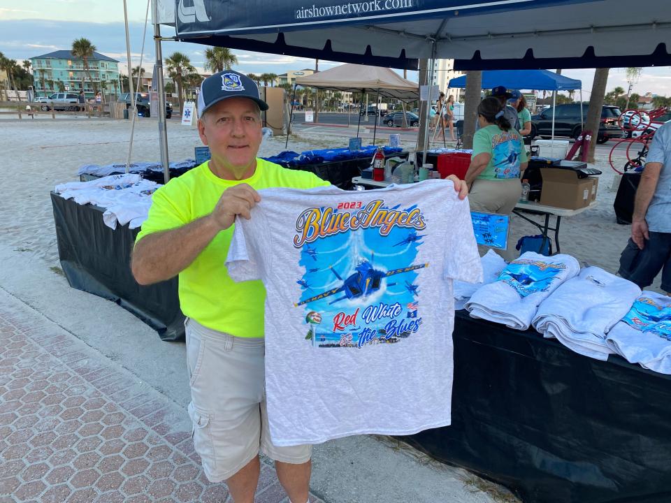 Currin Graphics owner David Currin prints their own Blue Angels shirts and towels specific to the Pensacola Beach Air Show.