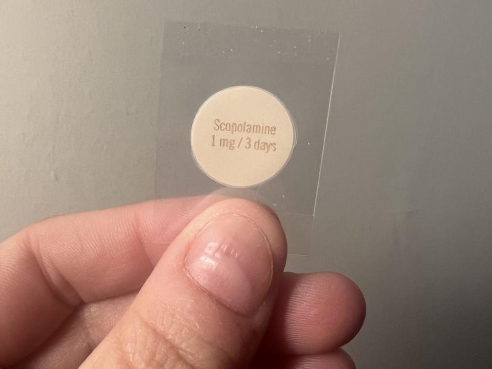 The Scopolamine patch goes behind your ear. My doctor instructed me to only use half of the patch, which I put on about three hours before setting sail. It works for three days before needing to switch it out.