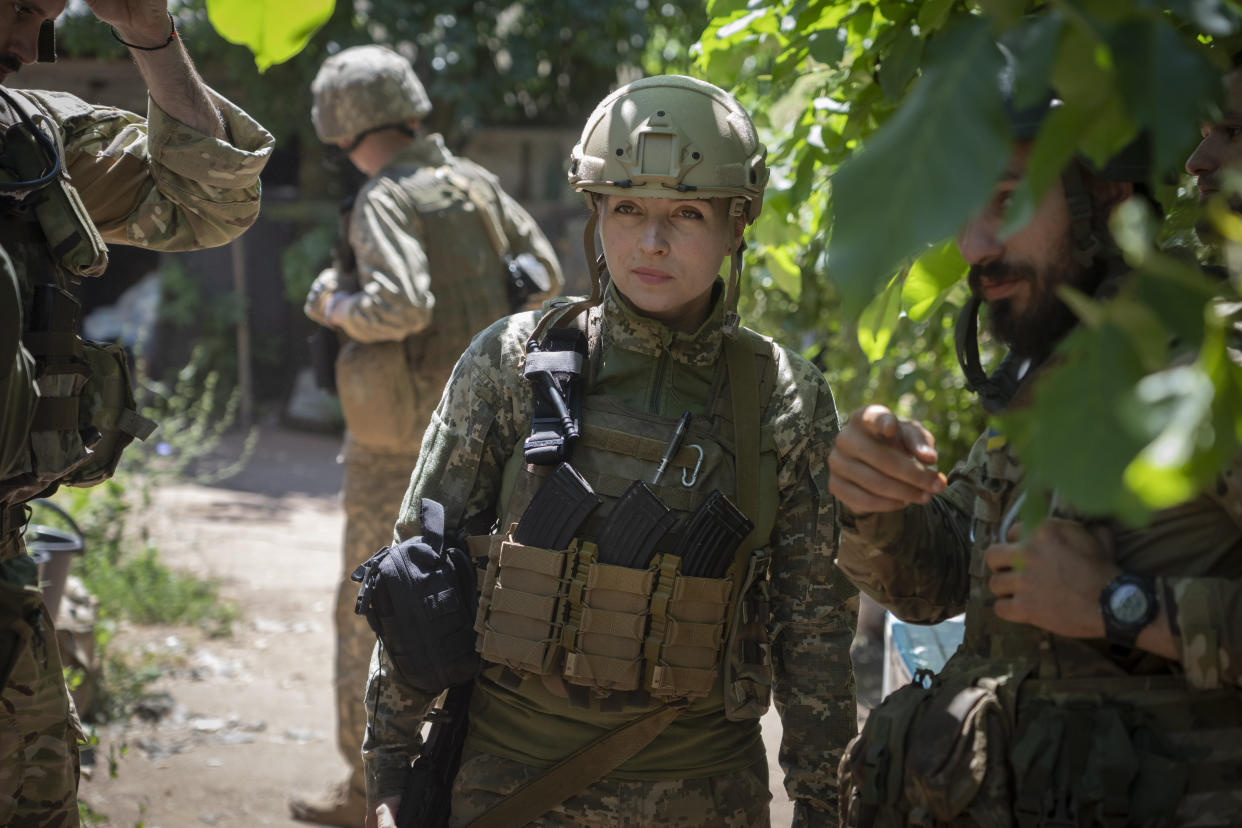 Ukrainian platoon commander Mariia talks to her soldiers in their position in the Donetsk region, Ukraine, Saturday, July 2, 2022. (AP Photo/Efrem Lukatsky)