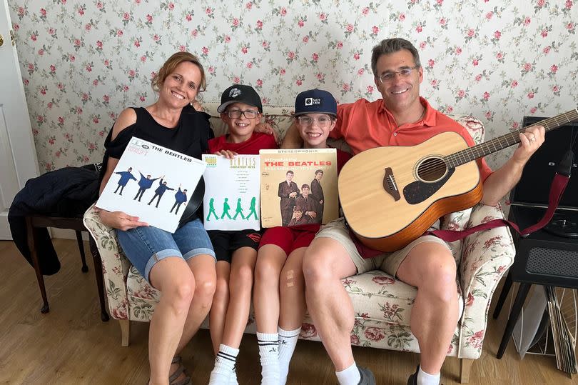 Beatles fan Ken Lambert with his wife Danielle, and sons Kolten and Sheadon in the home