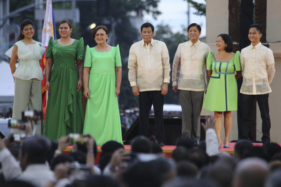 Philippine Vice President-elect Sara Duterte, second from left, poses with, from left, Senator Imee Marcos, her mother Elizabeth Zimmerman, outgoing Philippine President Rodrigo Duterte, incoming Philippine President Ferdinand "Bongbong" Marcos Jr., Liza and Sandro Marcos, after her oath taking rites as vice president in her hometown in Davao city, southern Philippines on Sunday June 19, 2022. Duterte clinched a landslide electoral victory despite her father's human rights record that saw thousands of drug suspects gunned down. (AP Photo/Manman Dejeto)