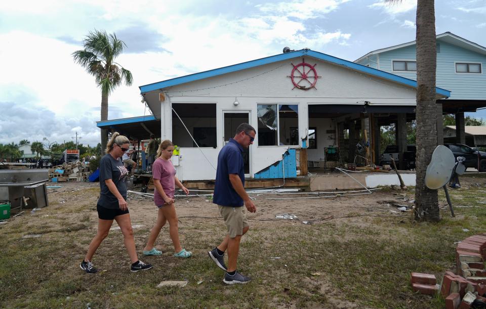 Residents survey the damage in Horseshoe Beach on Aug. 31, 2023 after Hurricane Idalia made landfall on the Gulf Coast of Florida.