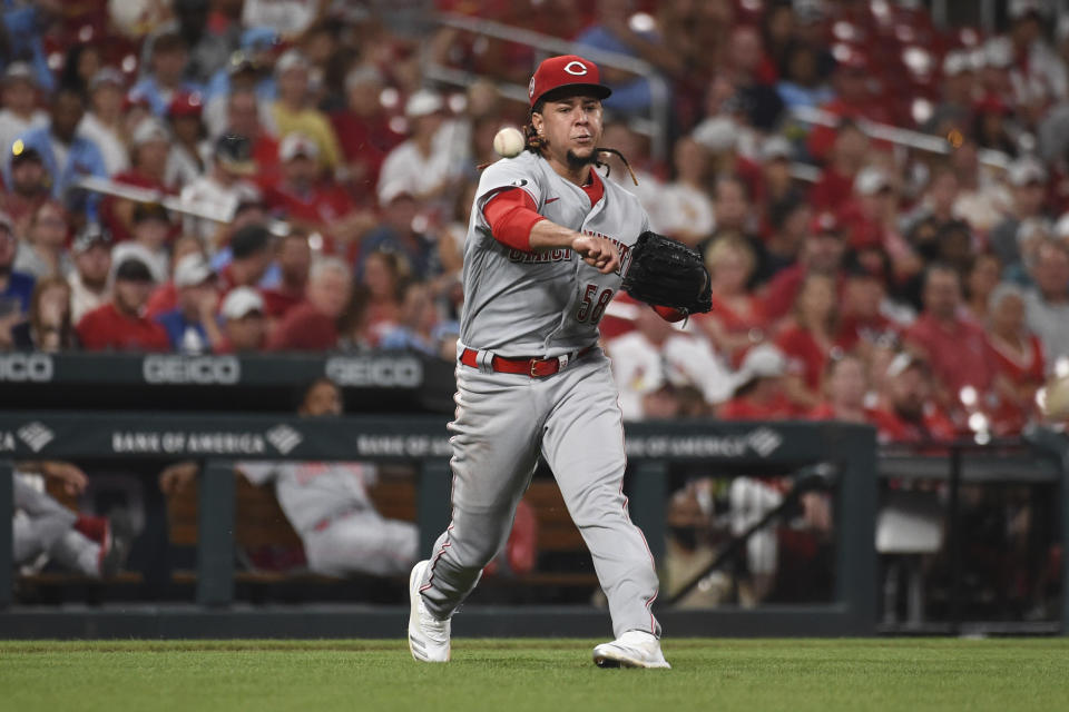 Cincinnati Reds starting pitcher Luis Castillo attempts to throw out St. Louis Cardinals' Tyler O'Neill at first base during the sixth inning of a baseball game on Saturday, Sept. 11, 2021, in St. Louis. (AP Photo/Joe Puetz)
