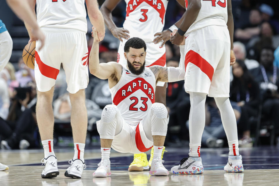 Toronto Raptors guard Fred VanVleet (23) grimmaces as he is helped up during the second half of an NBA basketball game against the Charlotte Hornets in Charlotte, N.C., Sunday, April 2, 2023. Toronto won 128-108. (AP Photo/Nell Redmond)