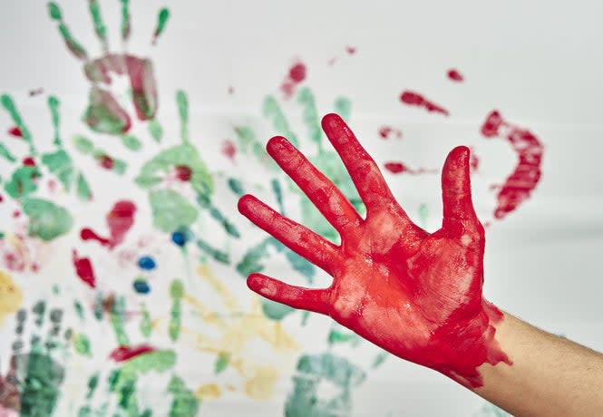 A hand covered in paint