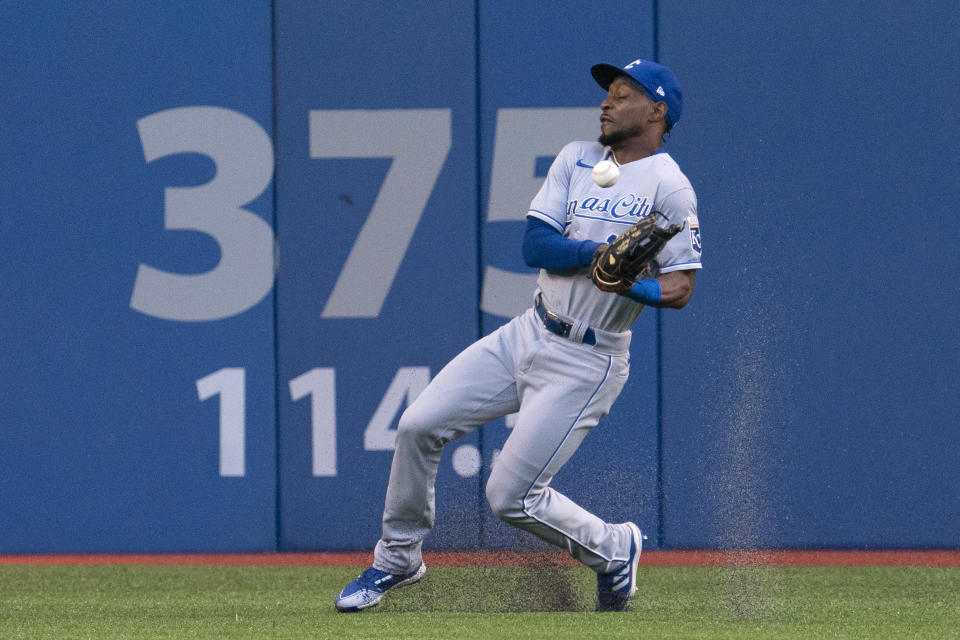 Kansas City Royals right fielder Jarrod Dyson (1) bobbles a ball off the bat of Toronto Blue Jays' Vladimir Guerrero Jr. during a baseball game Friday, July 30, 2021, in Toronto. The Blue Jays were playing in Toronto for the first time since the COVID-19 pandemic began. (Peter Power/The Canadian Press via AP)