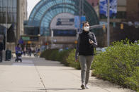 Mikela Earley walks to a hotel for an order for a customer who is inside of the bubble while in town for the NCAA men's college basketball tournament, Tuesday, March 30, 2021, in Indianapolis. The NCAA and local organizing groups set up expanded ambassador and item-delivery services relying on volunteer help to take care of needs for players, officials and others working inside. (AP Photo/Darron Cummings)