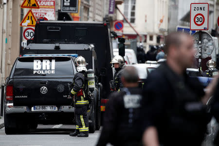 French police, special police forces (BRI) and firemen secure the street as a man has taken two people hostage at a business in Paris, France, June 12, 2018. REUTERS/Benoit Tessier