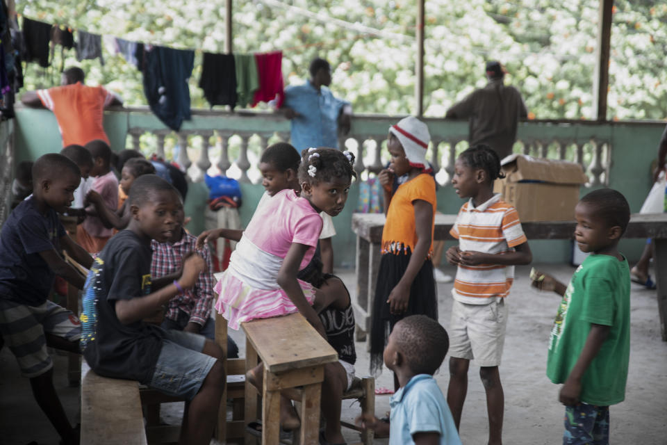 Children take refuge in a converted shelter after being forced to leave their homes due to clashes between armed gangs, in the Tabarre neighborhood of Port-au-Prince, Haiti, Thursday, April 28, 2022. About 1,700 schools have shuttered amid the spike in gang violence, leaving more than half a million children without an education said the United Nations. (AP Photo/Odelyn Joseph)