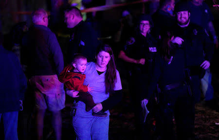 A woman who was shopping with her child during a shooting at a Walmart leaves the area in Thornton, Colorado November 1, 2017. REUTERS/Rick Wilking