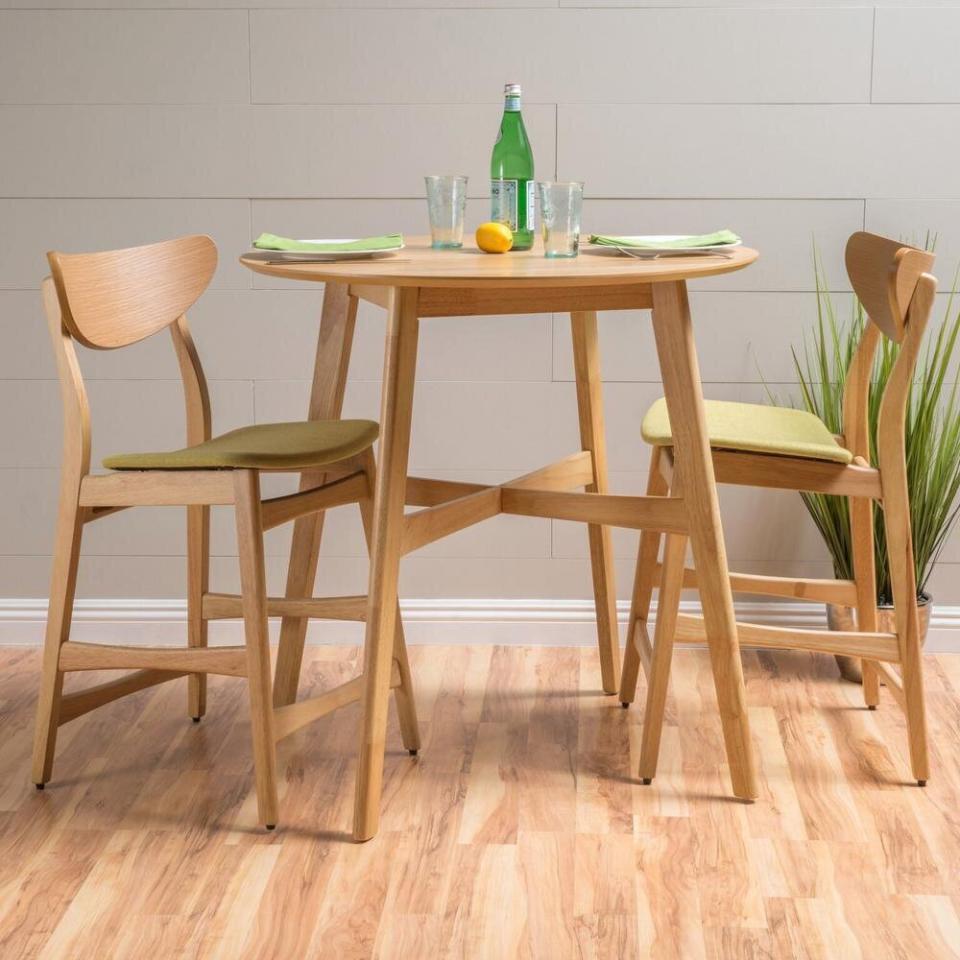 For dinners for two, you should check out this three-piece dining set that includes the table and two cushioned chairs in an oak finish. In a shade of "green tea," these chairs will brighten up your dining space, too. <a href="https://fave.co/3ddRfxo" target="_blank" rel="noopener noreferrer">Originally $293, get the set now for $258 at The Home Depot</a>.