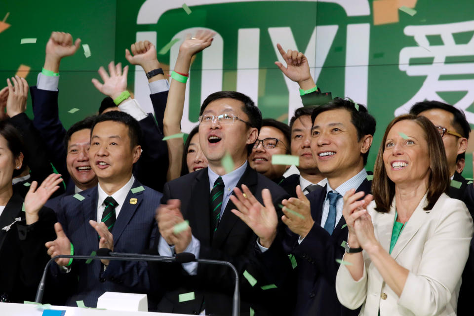 iQIYI Founder & CEO Yu Gong, center, and Robin Li, second from right, co-founder of the search engine Baidu, ring the Nasdaq MarketSite opening bell, during iQIYI IPO listing ceremonies, in New York's Times Square, Thursday, March 29, 2018. Nasdaq CEO Adena Friedman is at right. (AP Photo/Richard Drew)