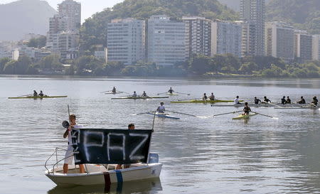 Members of the State Federation of Rowing and others take part in a protest against violence at Rodrigo de Freitas lagoon, where a cyclist was killed the week before during a bicycle robbery, in Rio de Janeiro, Brazil, in this file picture taken May 24, 2015. REUTERS/Sergio Moraes/Files