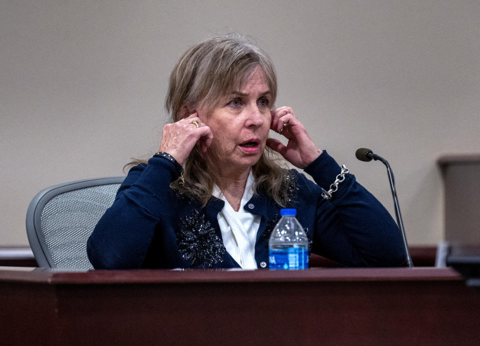 Mamie Elizabeth Mitchell, a script supervisor, testifies in the trial against Hannah Gutierrez-Reed, in First District Court, in Santa Fe, N.M., Thursday, February 22, 2024. She was describing that you normally plug your ears and open your mouth during gunshots. Gutierrez-Reed, who was working as the armorer on the movie "Rust" when a revolver actor Alec Baldwin was holding fired killing cinematographer Halyna Hutchins and injuring Souza, is charged with involuntary manslaughter and tampering with evidence.