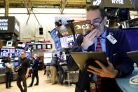 Traders work on the floor at the NYSE in New York