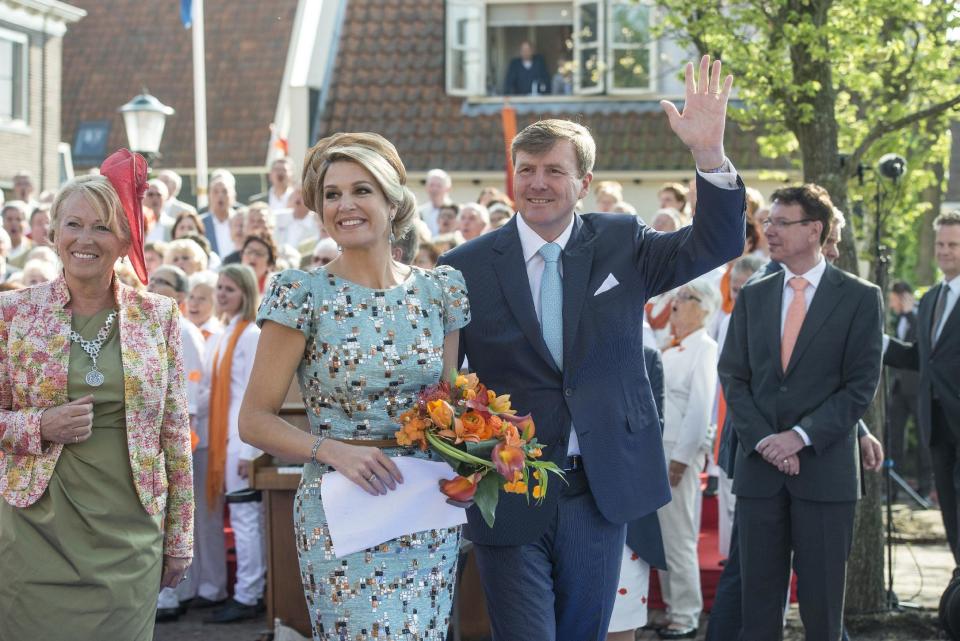 Netherlands' King Willem Alexander, right, waves to well wishers as Queen Maxima, left, looks on at the end of festivities marking King's Day in De Rijp, 36 kilometers (22 miles) north of Amsterdam, Netherlands, Saturday, April 26, 2014. The Dutch marked King's Day on Saturday, a national holiday held in honor of the newly installed monarch, King Willem Alexander. King's Day replaces the traditional Queen's Day. (AP Photo/Patrick Post)