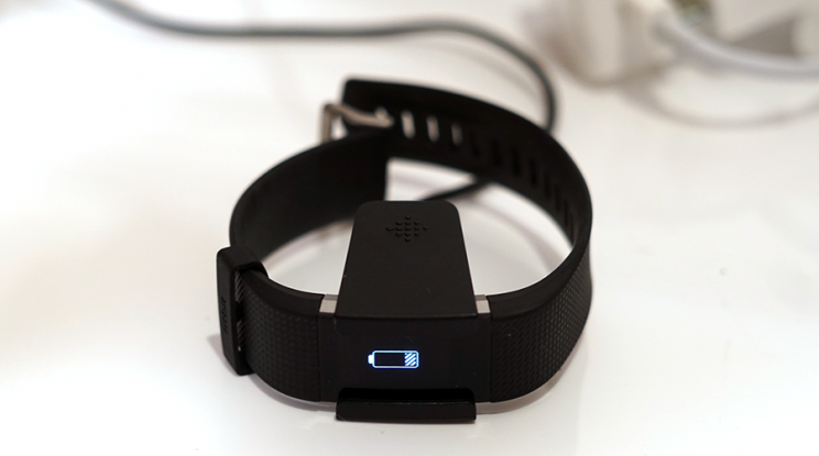 A plastic clamp charges up the Fitbit for six days.