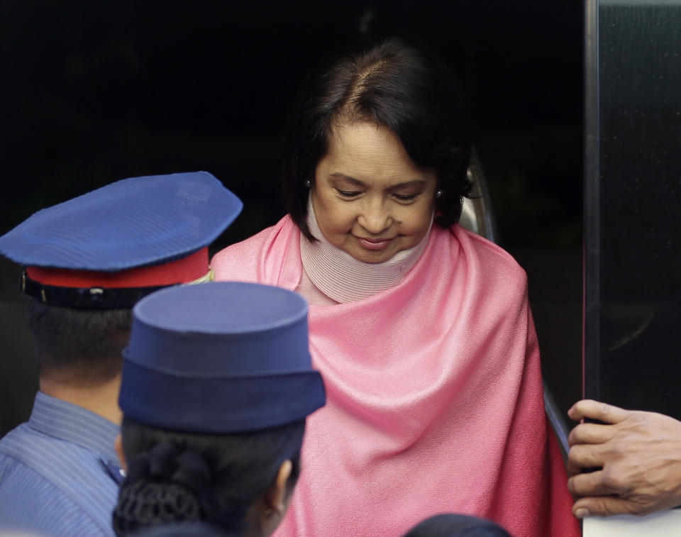 Former Philippine President Gloria Macapagal Arroyo, who is currently under hospital arrest, prepares to be wheeled into the courtroom of the Sandiganbayan (Anti-graft Court) upon arrival for her arraignment Monday, Oct. 29, 2012 at suburban Quezon city, northeast of Manila, Philippines. Arroyo, who is charged with plunder for allegedly misusing state lottery funds, refused to enter a plea and the anti-graft court entered a not guilty plea on her behalf. (AP Photo/Bullit Marquez)