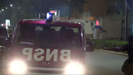 An armoured vehicle (behind) opens fire in the direction of a restaurant following an attack by gunmen on the restaurant in Ouagadougou, Burkina Faso, in this still frame taken from video August 13, 2017. REUTERS/Reuters TV