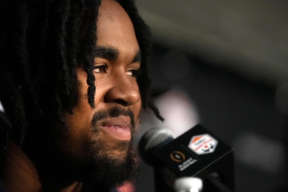 Michigan Wolverines running back Donovan Edwards answers media questions as the football team arrives at Sky Harbor International Airport on Monday, Dec. 26, 2022, ahead of their College Football Playoff Semifinal at the Vrbo Fiesta Bowl against the TCU Horned Frogs. 